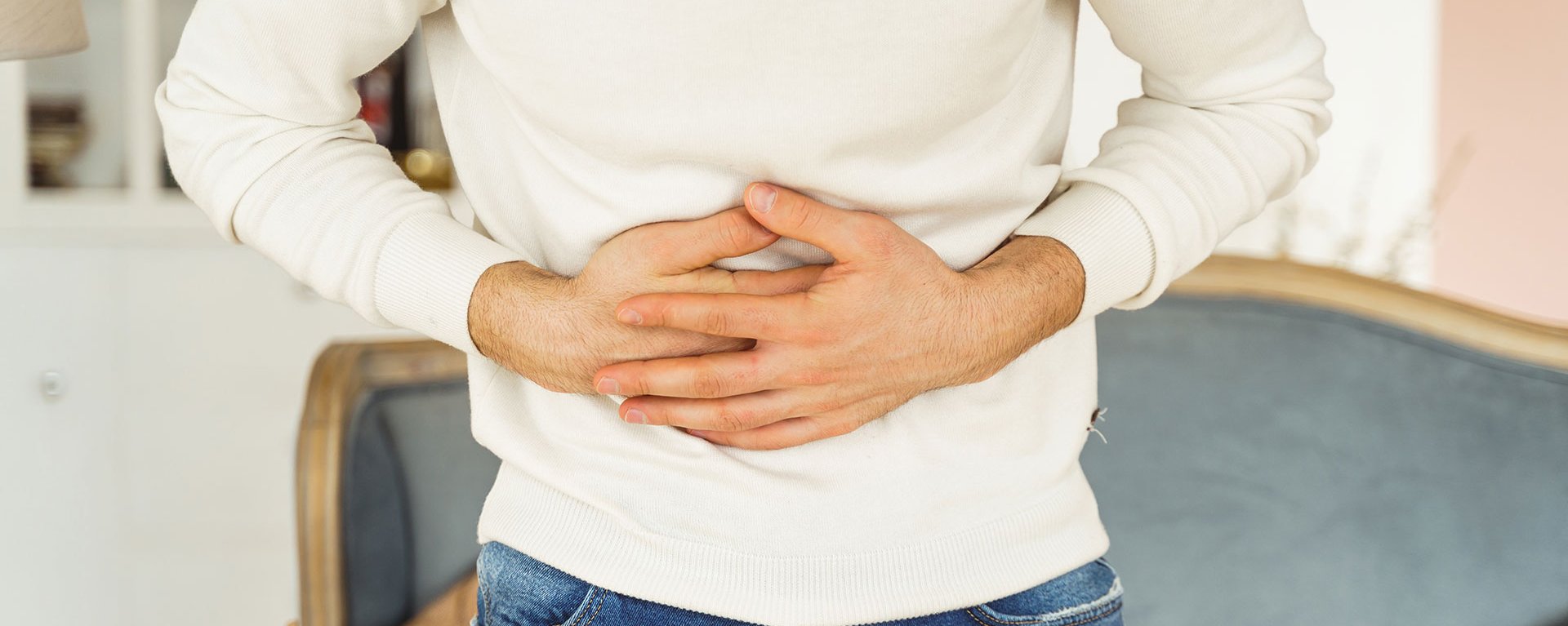 Mann mit Schmerzen in der Bauchregion kann in der Gastroenterologie in der Klinik Mindelheim geholfen werden